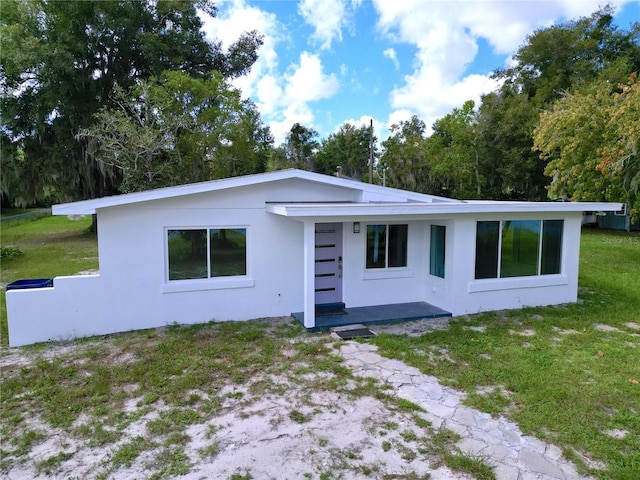 407 Sheryl Dr, Deltona, FL 32738 - rear view of house featuring a lawn and stucco siding