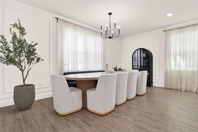 dining room with a wealth of natural light, a notable chandelier, and light wood-style flooring