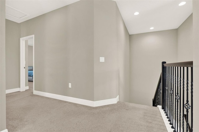 interior space with baseboards, an upstairs landing, carpet, recessed lighting, and attic access