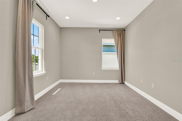 spare room with recessed lighting, carpet flooring, and baseboards