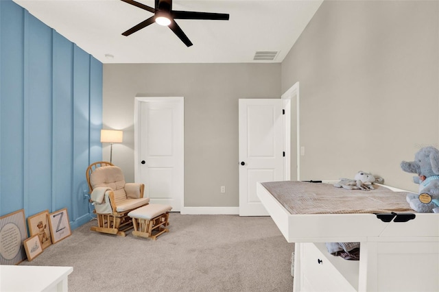 office with light carpet, a ceiling fan, and visible vents