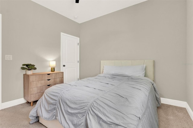 carpeted bedroom featuring baseboards and ceiling fan