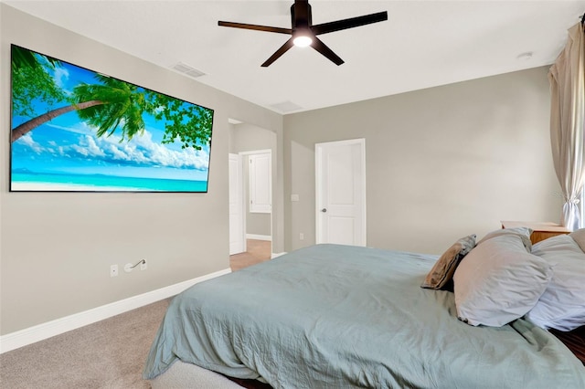 carpeted bedroom with visible vents, baseboards, and a ceiling fan