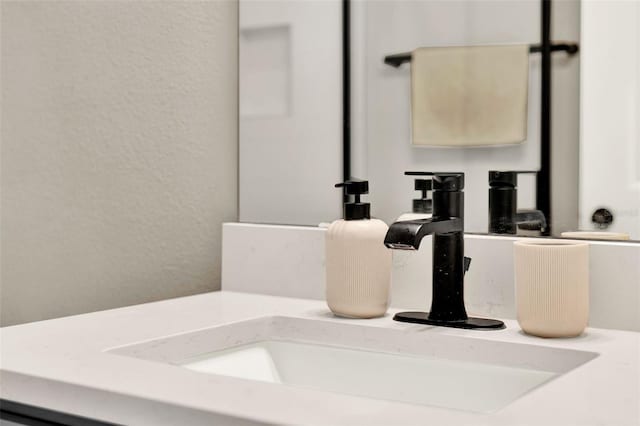 details featuring a sink and a textured wall