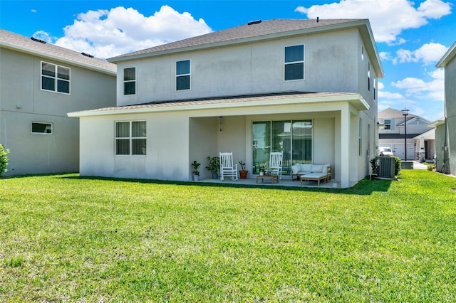 back of property with central air condition unit, a shingled roof, stucco siding, and a lawn
