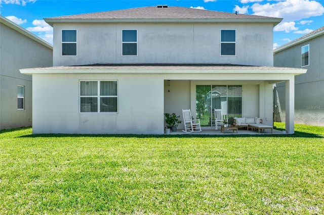 back of property featuring a yard, an outdoor living space, a shingled roof, and stucco siding