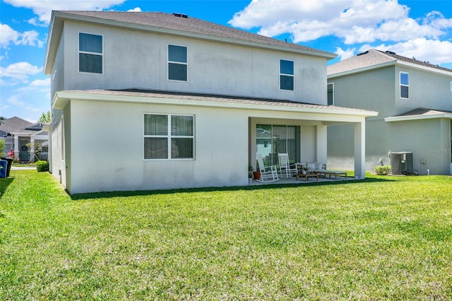 back of property with cooling unit, a patio, stucco siding, and a lawn