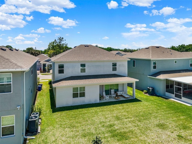 rear view of house with cooling unit, a patio, a lawn, and stucco siding
