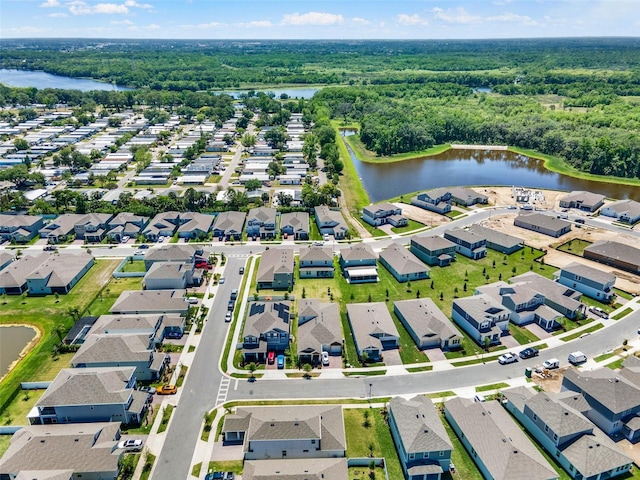drone / aerial view with a water view, a forest view, and a residential view
