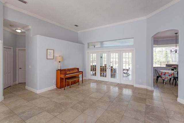 4556 Serna Ave, Malabar, FL 32950 - empty room featuring arched walkways, ornamental molding, french doors, and a chandelier