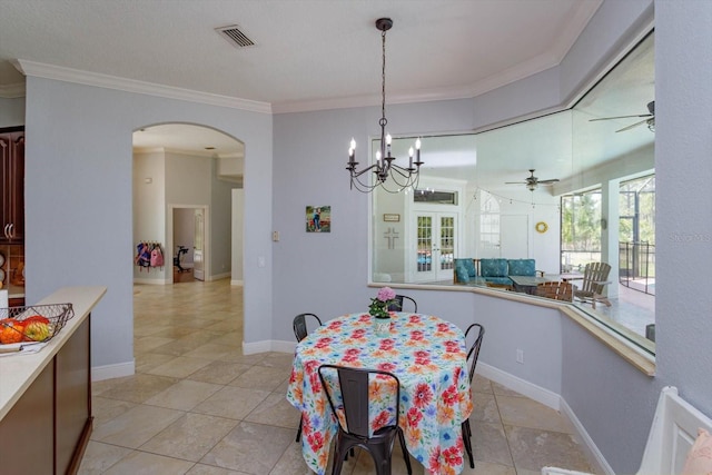 4556 Serna Ave, Malabar, FL 32950 - dining space with arched walkways, crown molding, ceiling fan, a chandelier, and light tile patterned floors