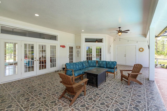 4556 Serna Ave, Malabar, FL 32950 - living room with french doors, stone floors, healthy amount of natural light, a textured ceiling, and a ceiling fan