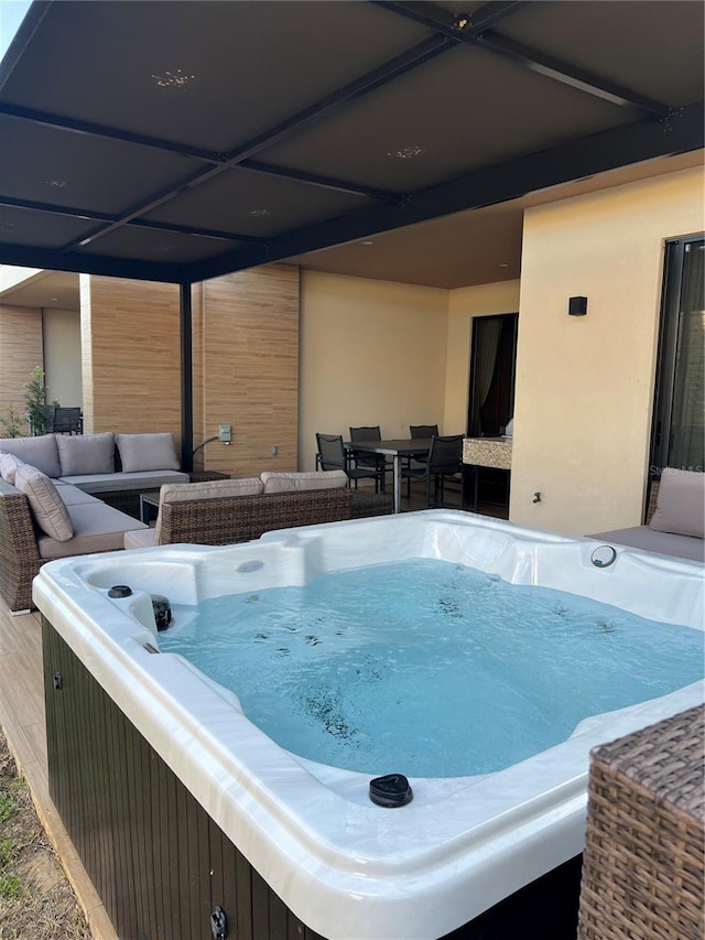 exterior space with outdoor dining area and a hot tub