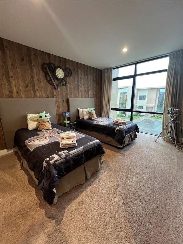 carpeted bedroom featuring wood walls
