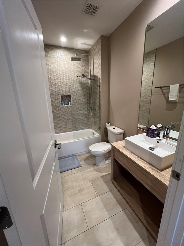 bathroom featuring visible vents, tile patterned flooring, vanity, tub / shower combination, and toilet