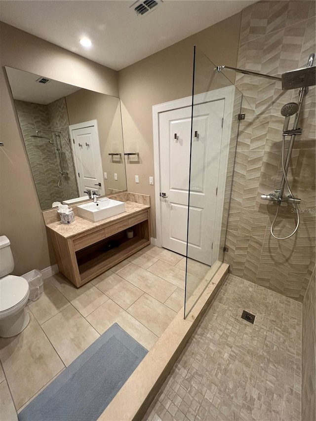 bathroom featuring visible vents, walk in shower, vanity, toilet, and recessed lighting