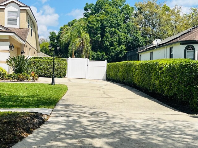 702 Palenci Ct, Winter Springs, FL 32708 - exterior space featuring fence, a gate, and concrete driveway