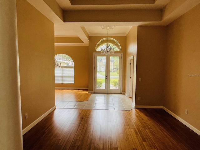 702 Palenci Ct, Winter Springs, FL 32708 - foyer entrance with baseboards, a raised ceiling, a chandelier, and hardwood / wood-style flooring