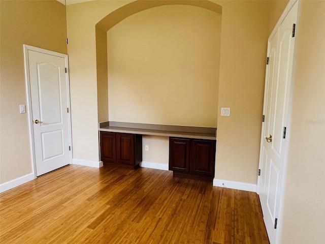 702 Palenci Ct, Winter Springs, FL 32708 - unfurnished office with arched walkways, wood finished floors, baseboards, and built in study area