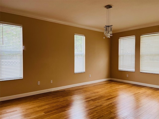 702 Palenci Ct, Winter Springs, FL 32708 - unfurnished room with a chandelier, wood finished floors, and ornamental molding