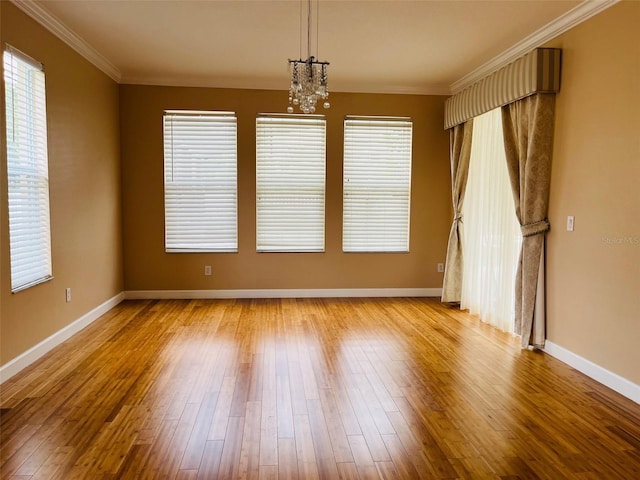 702 Palenci Ct, Winter Springs, FL 32708 - empty room featuring plenty of natural light, a notable chandelier, and wood finished floors