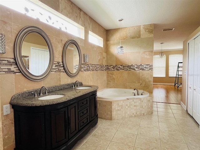 702 Palenci Ct, Winter Springs, FL 32708 - full bath featuring a sink, tile walls, a bath, and a wealth of natural light