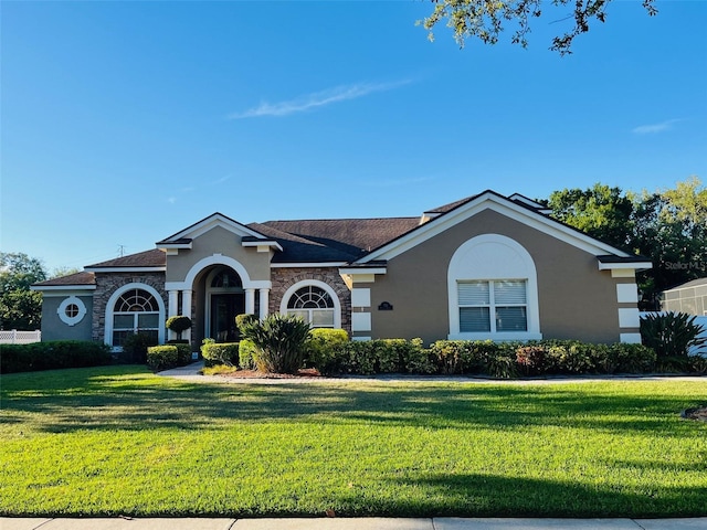 702 Palenci Ct, Winter Springs, FL 32708 - view of front of house featuring stucco siding, stone siding, and a front lawn