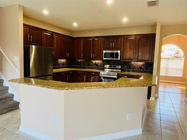 702 Palenci Ct, Winter Springs, FL 32708 - kitchen with tasteful backsplash, light stone countertops, light tile patterned flooring, and appliances with stainless steel finishes
