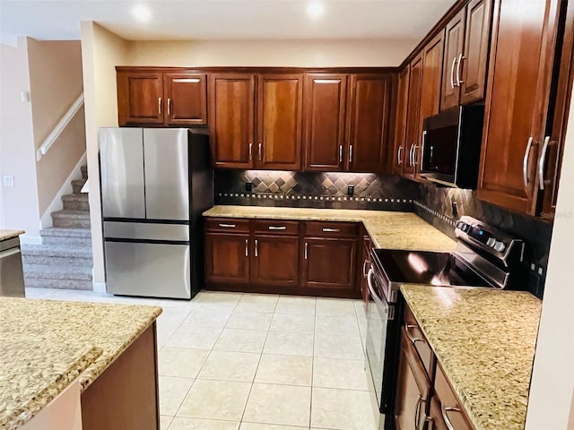 702 Palenci Ct, Winter Springs, FL 32708 - kitchen featuring tasteful backsplash, light stone countertops, light tile patterned floors, and appliances with stainless steel finishes