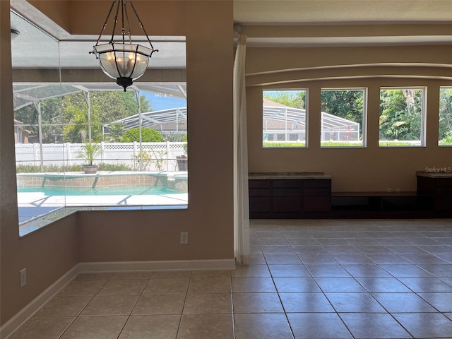 702 Palenci Ct, Winter Springs, FL 32708 - unfurnished dining area with a wealth of natural light, tile patterned flooring, and baseboards