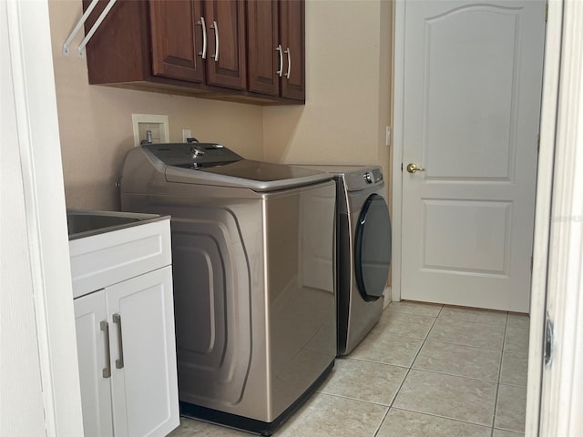 702 Palenci Ct, Winter Springs, FL 32708 - laundry area featuring washing machine and dryer, light tile patterned flooring, and cabinet space