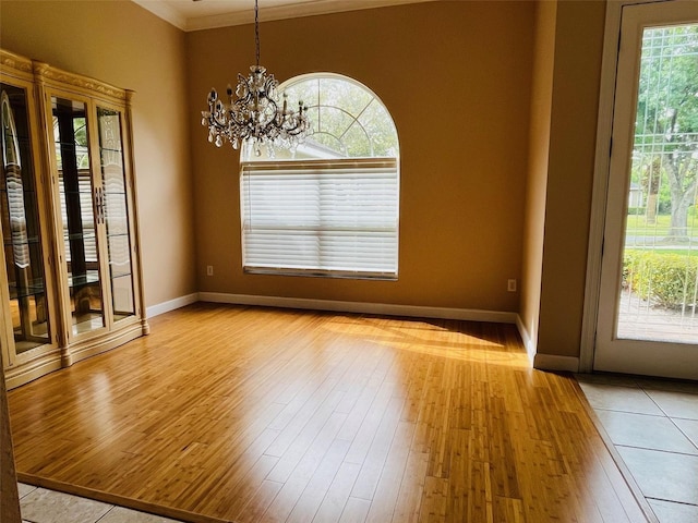 702 Palenci Ct, Winter Springs, FL 32708 - unfurnished dining area with crown molding, baseboards, a chandelier, and hardwood / wood-style flooring