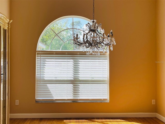 702 Palenci Ct, Winter Springs, FL 32708 - room details with wood finished floors, an inviting chandelier, and baseboards