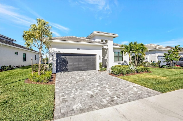 15865 Key Biscayne Ln, Loxahatchee, FL 33470 - view of front facade with an attached garage, a front yard, decorative driveway, and stucco siding