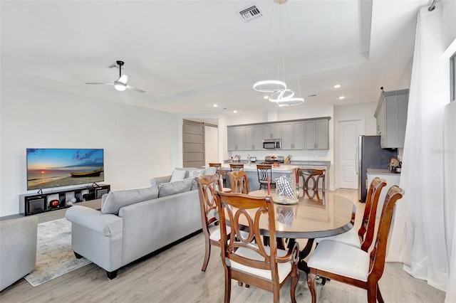 15865 Key Biscayne Ln, Loxahatchee, FL 33470 - dining room with a tray ceiling, light wood finished floors, recessed lighting, and a ceiling fan