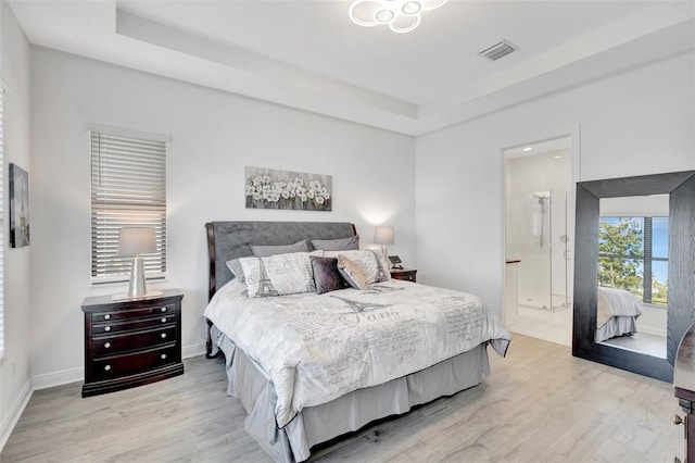 15865 Key Biscayne Ln, Loxahatchee, FL 33470 - bedroom with light wood-style flooring, a tray ceiling, and baseboards