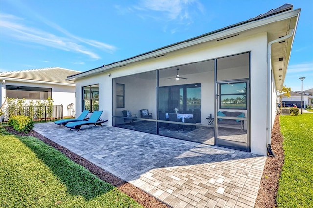 15865 Key Biscayne Ln, Loxahatchee, FL 33470 - back of property with a patio area, ceiling fan, and stucco siding