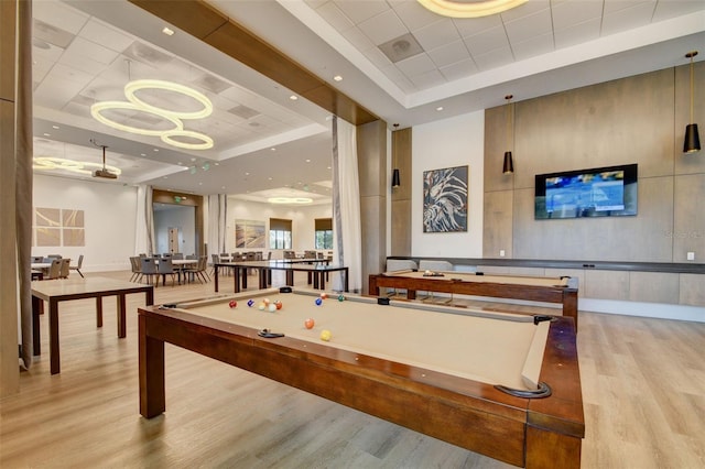 15865 Key Biscayne Ln, Loxahatchee, FL 33470 - playroom featuring a tray ceiling, wood finished floors, and baseboards