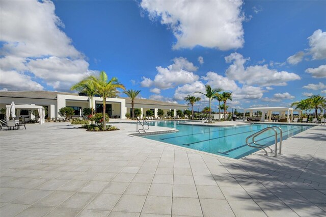 15865 Key Biscayne Ln, Loxahatchee, FL 33470 - community pool featuring a patio