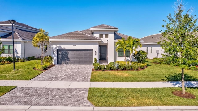 15865 Key Biscayne Ln, Loxahatchee, FL 33470 - view of front of house featuring a garage, a front yard, stucco siding, decorative driveway, and a tile roof