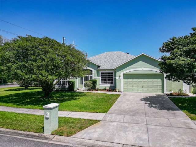 1157 Valley Creek Run, Winter Park, FL 32792 - view of front of house featuring a garage, a front lawn, roof with shingles, stucco siding, and driveway