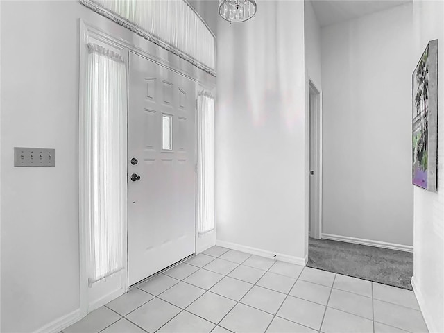 1157 Valley Creek Run, Winter Park, FL 32792 - entryway featuring baseboards, light carpet, light tile patterned flooring, and a notable chandelier
