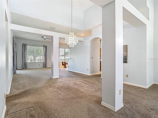 1157 Valley Creek Run, Winter Park, FL 32792 - unfurnished dining area with ceiling fan with notable chandelier, arched walkways, baseboards, and carpet flooring