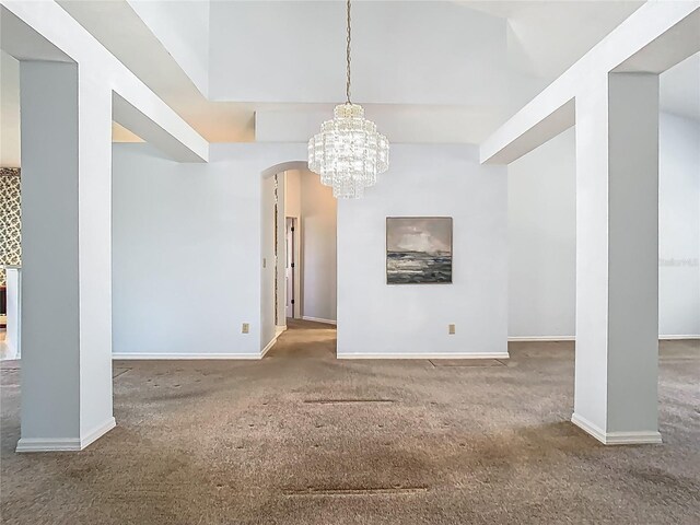 1157 Valley Creek Run, Winter Park, FL 32792 - unfurnished living room featuring an inviting chandelier, arched walkways, baseboards, and carpet flooring