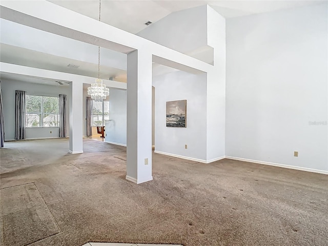 1157 Valley Creek Run, Winter Park, FL 32792 - unfurnished living room with visible vents, high vaulted ceiling, baseboards, a chandelier, and carpet flooring