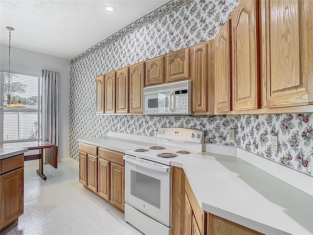1157 Valley Creek Run, Winter Park, FL 32792 - kitchen featuring light countertops, white appliances, and wallpapered walls