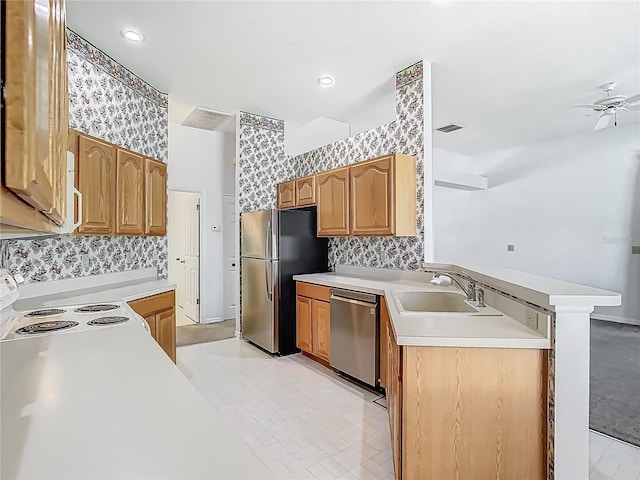 1157 Valley Creek Run, Winter Park, FL 32792 - kitchen featuring a peninsula, wallpapered walls, light countertops, a sink, and stainless steel appliances