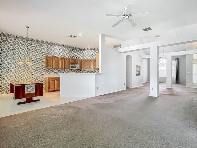 1157 Valley Creek Run, Winter Park, FL 32792 - unfurnished living room with arched walkways, baseboards, ceiling fan with notable chandelier, and visible vents