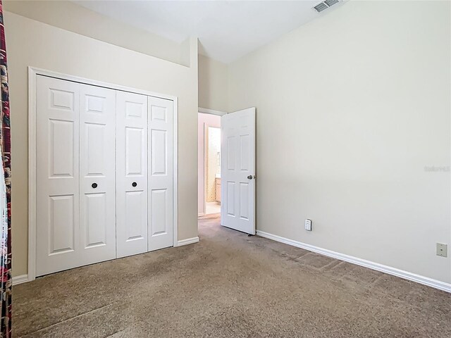 1157 Valley Creek Run, Winter Park, FL 32792 - unfurnished bedroom featuring carpet floors, baseboards, a closet, and visible vents
