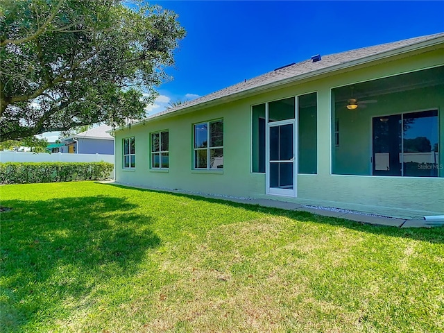 1157 Valley Creek Run, Winter Park, FL 32792 - rear view of house with a ceiling fan, stucco siding, and a yard